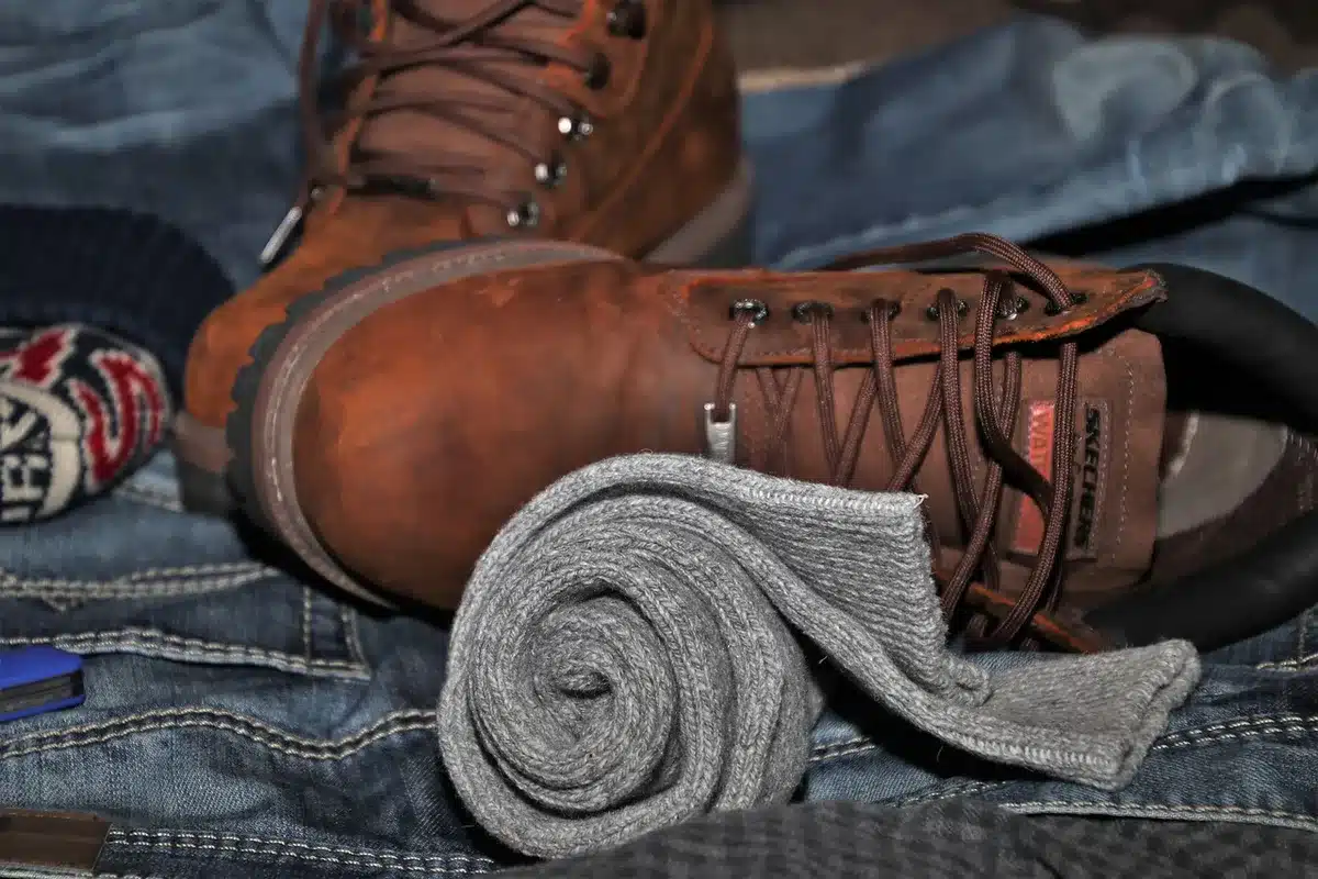 Gelaagde herfstoutfit met crèmekleurige trui en lange jas in natuurlijke tinten