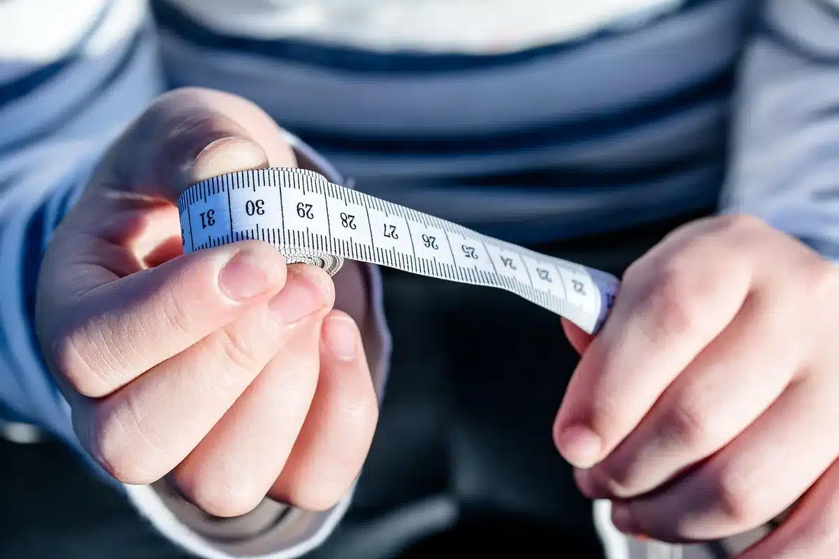 Meetlint en weegschaal die BMI en taille benadrukken